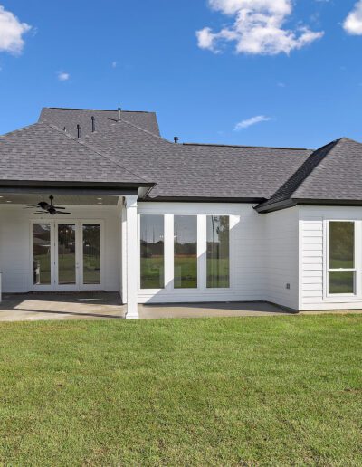 New suburban house with a screened porch and a large backyard.