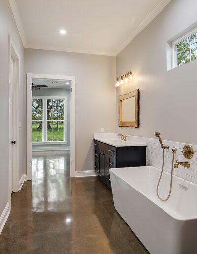 Modern bathroom with a white freestanding tub, walk-in shower, and dual vanity.