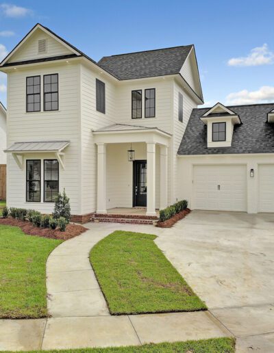 New suburban two-story home with detached garage and landscaped front yard.